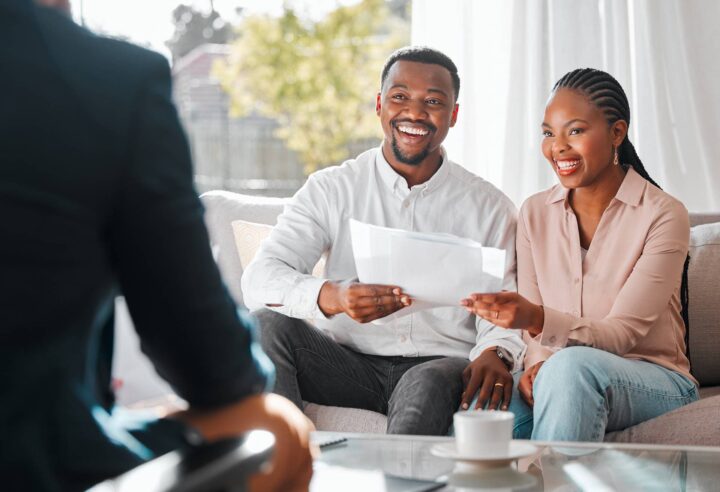 A young couple meeting with an agent for the first time