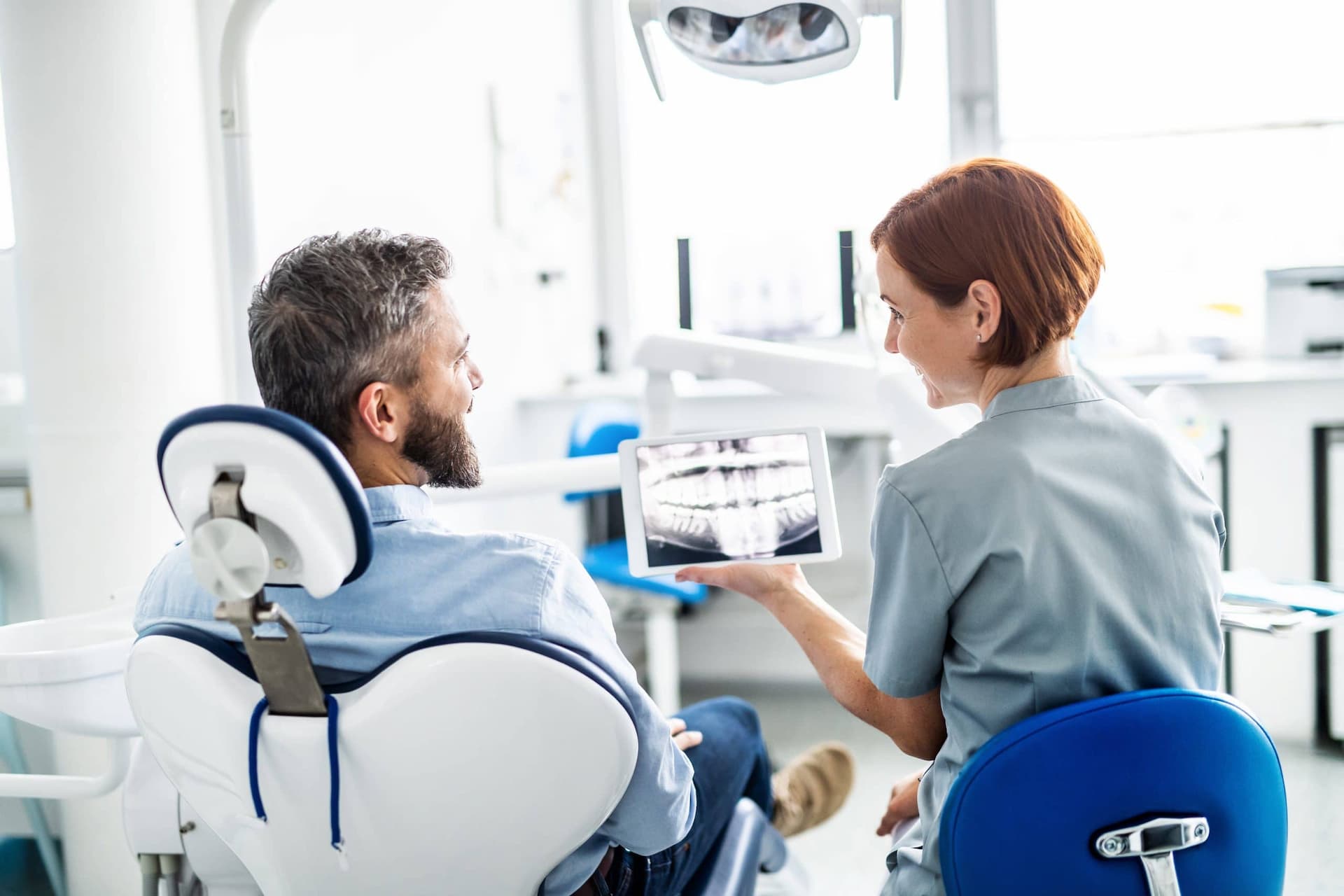 A dentist reviewing an x-ray with her patient