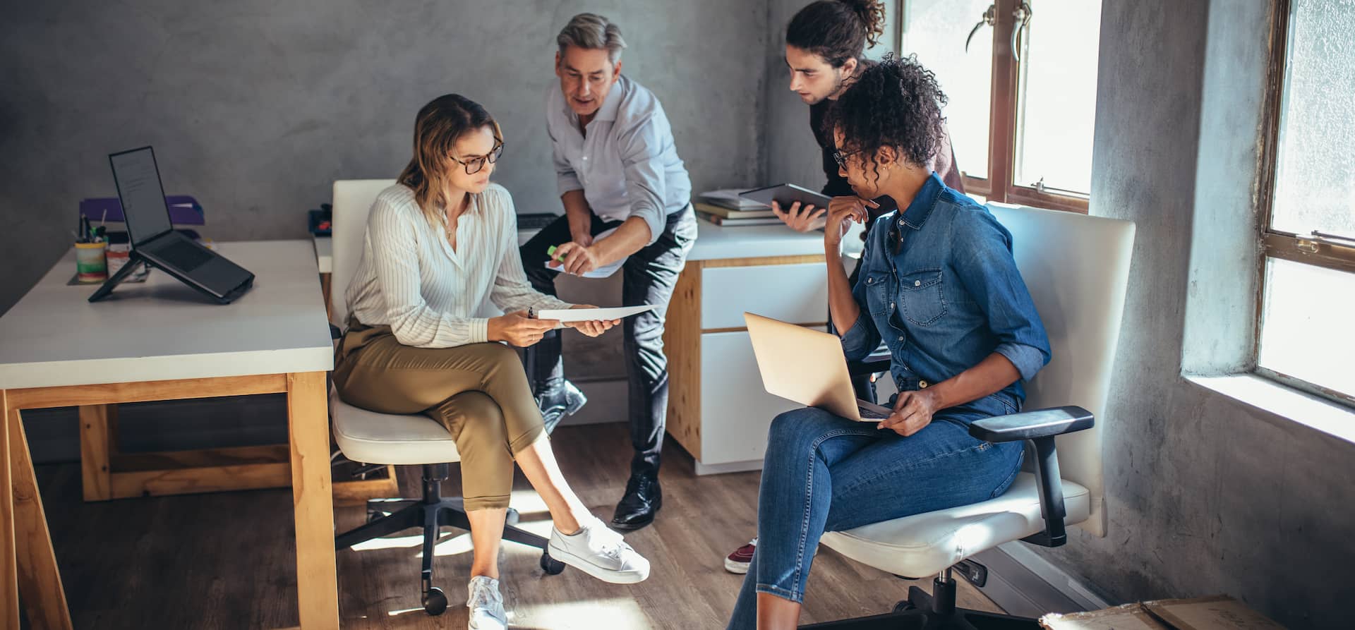 An insurance agent talking to brokers while sitting around an office