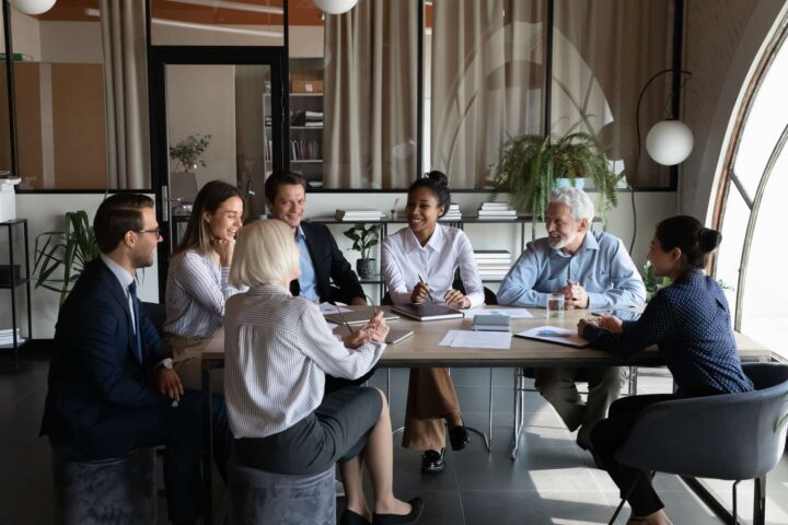 A group of agents gathered at a table for a business meeting
