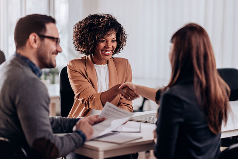 An insurance agent shaking hands with a client