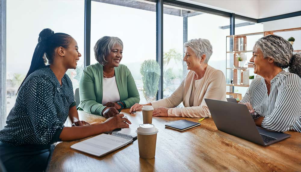 A pair of insurance agents giving feedback to two other agents