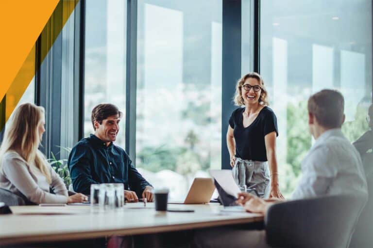 Agents and clients meeting at a table in a well-lit room.