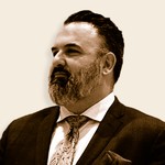 Professional man in suit with a confident expression, looking to the side.