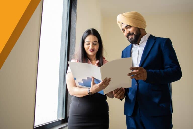 Insurance broker and MGA partner reviewing product documents together in a Canadian office